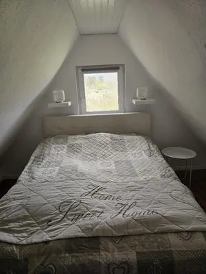 Ein Bett oder Betten in einem Zimmer der Unterkunft Reetdachhaus am See