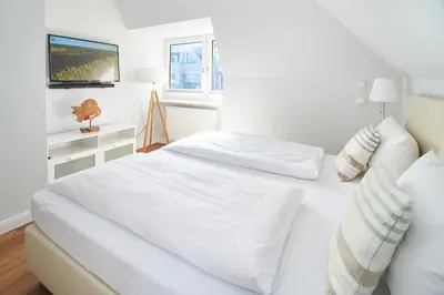 Ein Bett oder Betten in einem Zimmer der Unterkunft Villa Dünenblick Beachhouse Apartment Sunset