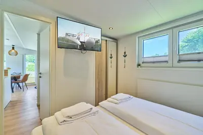 Ein Bett oder Betten in einem Zimmer der Unterkunft Ostseecamp Ferienhaus 