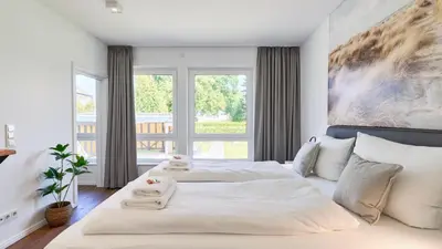 Ein Bett oder Betten in einem Zimmer der Unterkunft Haus Meerzeit, Wohnung Düne, 250 m vom Strand, Hunde willkommen