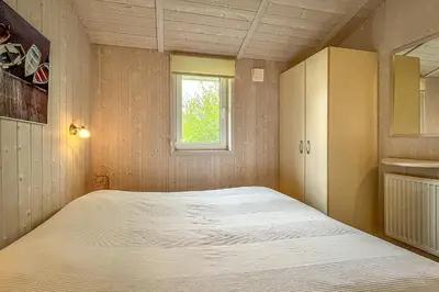 Ein Bett oder Betten in einem Zimmer der Unterkunft Pulverhorn - Dorf 4 Ferienhaus 3
