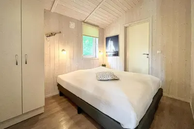 Ein Bett oder Betten in einem Zimmer der Unterkunft Pulverhorn - Dorf 4 Ferienhaus 01