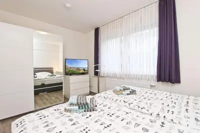 Ein Bett oder Betten in einem Zimmer der Unterkunft Appartementhaus Zur Sonne - Whg. 2