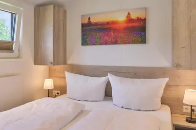 Ein Bett oder Betten in einem Zimmer der Unterkunft Ostseecamp Ferienhaus 