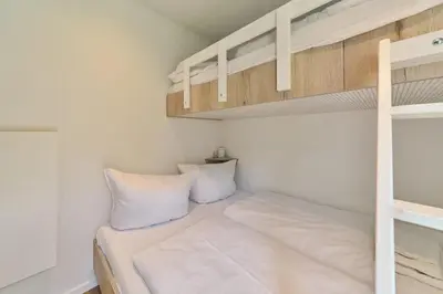 Ein Bett oder Betten in einem Zimmer der Unterkunft Ostseecamp Ferienhaus 