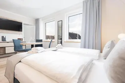 Ein Bett oder Betten in einem Zimmer der Unterkunft Apartments an der Vorderreihe - Parkplätze nach Verfügbarkeit