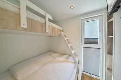 Ein Bett oder Betten in einem Zimmer der Unterkunft Ostseecamp Ferienhaus 