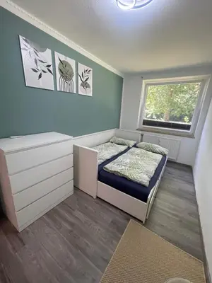 Ein Bett oder Betten in einem Zimmer der Unterkunft GartenOase Lübeck