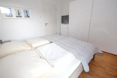 Ein Bett oder Betten in einem Zimmer der Unterkunft Europaweg, Fewo 131