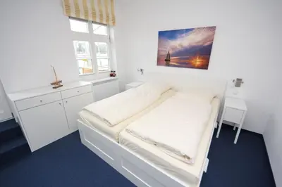 Ein Bett oder Betten in einem Zimmer der Unterkunft Vorderreihe, Fewo 107