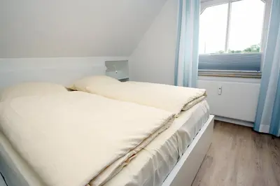 Ein Bett oder Betten in einem Zimmer der Unterkunft Vorderreihe, Fewo 157