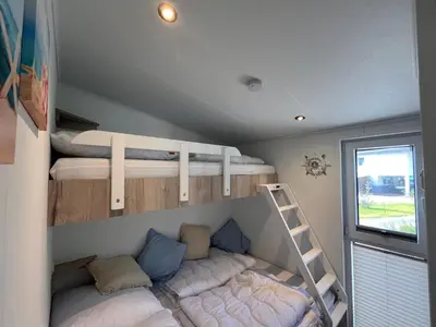Ein Bett oder Betten in einem Zimmer der Unterkunft Ostseecamp Ferienhaus Küstenklang