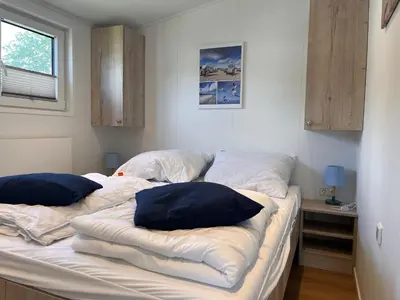 Ein Bett oder Betten in einem Zimmer der Unterkunft Ostseecamp Ferienhaus Küstenklang
