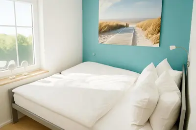 Ein Bett oder Betten in einem Zimmer der Unterkunft Ferienhaus Priwall