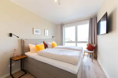 Ein Bett oder Betten in einem Zimmer der Unterkunft Ferienwohnung Villa Heidenreich Nr.3 - Scharbeutz