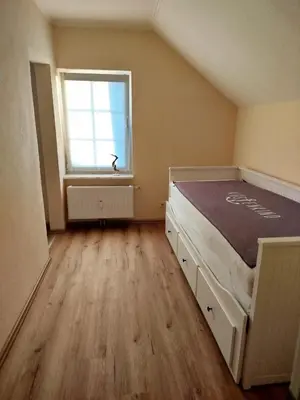 Ein Bett oder Betten in einem Zimmer der Unterkunft Villa Scharbeutz, Pönitz