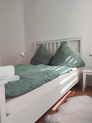 Ein Bett oder Betten in einem Zimmer der Unterkunft Ferienwohnung am Bahnhof Meierstr 43