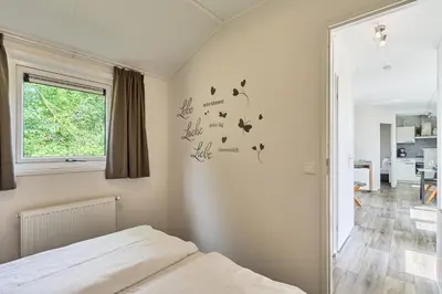 Ein Bett oder Betten in einem Zimmer der Unterkunft Süsel Seeparx Ferienhaus Tjelle