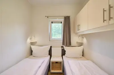 Ein Bett oder Betten in einem Zimmer der Unterkunft Süsel Seeparx Ferienhaus Biene