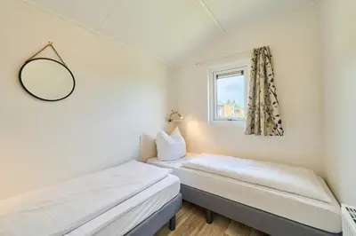 Ein Bett oder Betten in einem Zimmer der Unterkunft Süsel Seeparx Ferienhaus Iona