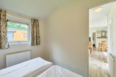 Ein Bett oder Betten in einem Zimmer der Unterkunft Süsel Seeparx Ferienhaus Iona
