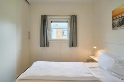 Ein Bett oder Betten in einem Zimmer der Unterkunft Süsel Seeparx Ferienhaus Windspiel