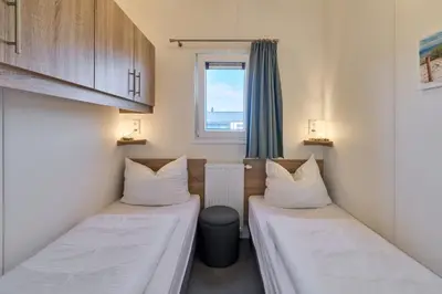 Ein Bett oder Betten in einem Zimmer der Unterkunft Süsel Seeparx Ferienhaus Chalet Relax-Inn