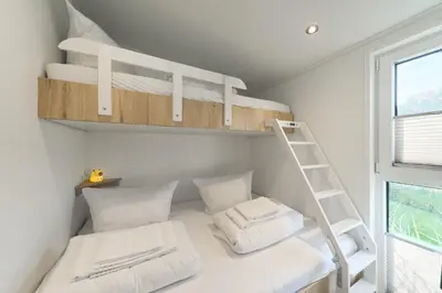 Ein Bett oder Betten in einem Zimmer der Unterkunft Ostseecamp Ferienhaus 