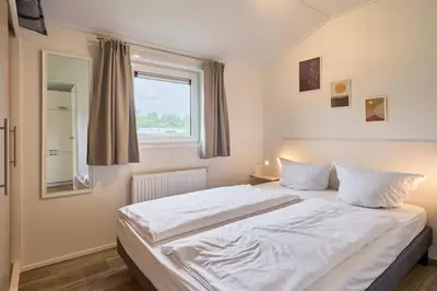 Ein Bett oder Betten in einem Zimmer der Unterkunft Süsel Seeparx Ferienhaus Carla