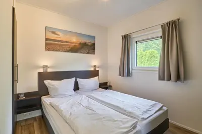 Ein Bett oder Betten in einem Zimmer der Unterkunft Süsel Seeparx Ferienhaus Sonnenschein