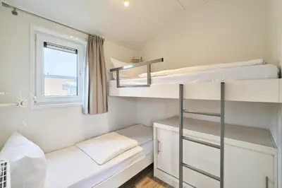Ein Bett oder Betten in einem Zimmer der Unterkunft Süsel Seeparx Ferienhaus Theres