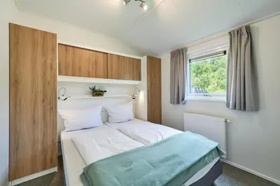 Ein Bett oder Betten in einem Zimmer der Unterkunft Süsel Seeparx Ferienhaus Seezeit