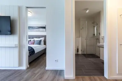 Ein Bett oder Betten in einem Zimmer der Unterkunft Godewindpark Deluxe-Apartment 1-10 mit Gartenblick