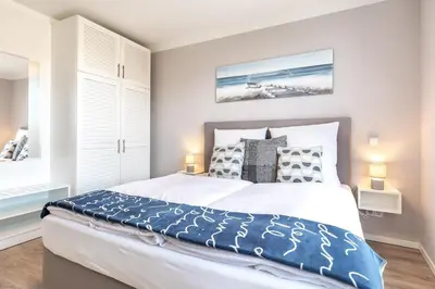 Ein Bett oder Betten in einem Zimmer der Unterkunft Godewindpark Exklusivsuite 3-01