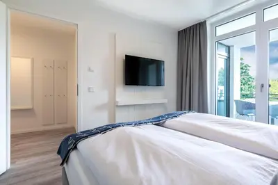 Ein Bett oder Betten in einem Zimmer der Unterkunft Godewindpark Deluxe-Apartment 2-04
