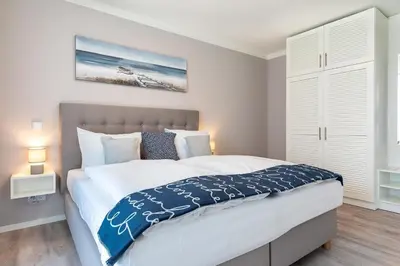 Ein Bett oder Betten in einem Zimmer der Unterkunft Godewindpark Deluxe-Suite 1-05 mit West-Loggia