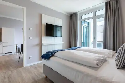 Ein Bett oder Betten in einem Zimmer der Unterkunft Godewindpark Exklusivsuite 3-09 mit Strandkorb am Strand