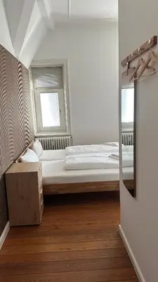 Ein Bett oder Betten in einem Zimmer der Unterkunft Hanse Room Lübeck