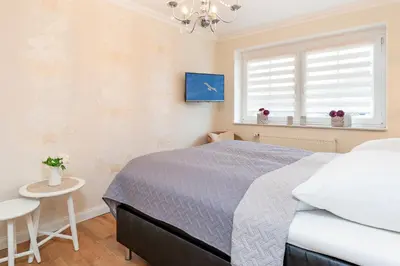 Ein Bett oder Betten in einem Zimmer der Unterkunft Strand Domizil Himmel & Meer