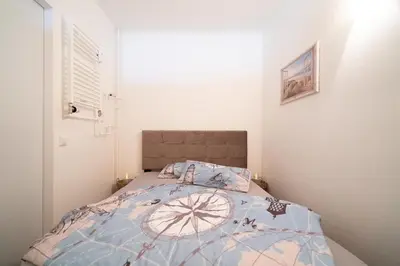 Ein Bett oder Betten in einem Zimmer der Unterkunft Giny's Beach Appartement