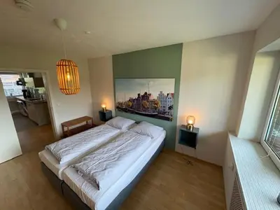 Ein Bett oder Betten in einem Zimmer der Unterkunft Aparthotel Am Mühlenteich