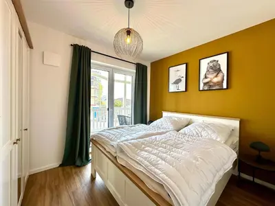 Ein Bett oder Betten in einem Zimmer der Unterkunft Salt & Sand Haffkrug Salt & Sand Wohnung Sun