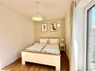Ein Bett oder Betten in einem Zimmer der Unterkunft Salt & Sand Haffkrug Salt & Sand Wohnung Sand