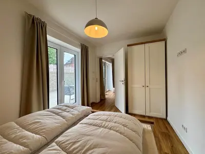 Ein Bett oder Betten in einem Zimmer der Unterkunft Salt & Sand Haffkrug Salt & Sand Wohnung Sand