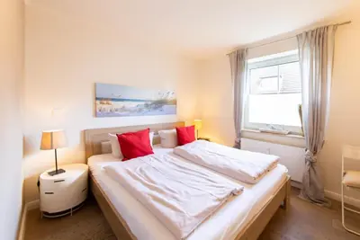 Ein Bett oder Betten in einem Zimmer der Unterkunft Ferienwohnung Strandglück - Timmendorfer Strand
