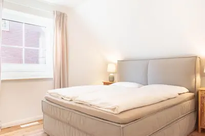 Ein Bett oder Betten in einem Zimmer der Unterkunft Ferienwohnung Lütt Strandhuus - Scharbeutz