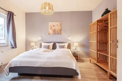 Ein Bett oder Betten in einem Zimmer der Unterkunft Gästehaus Daheim - Appartement 03