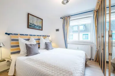 Ein Bett oder Betten in einem Zimmer der Unterkunft Domizil Strandburg App 6