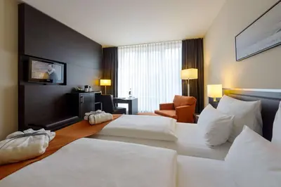 Ein Bett oder Betten in einem Zimmer der Unterkunft ATLANTIC Hotel Lübeck