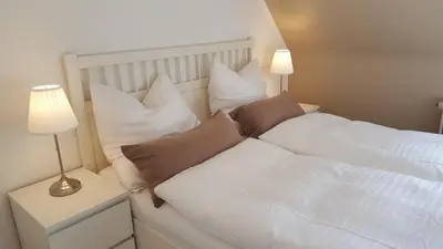 Ein Bett oder Betten in einem Zimmer der Unterkunft FeWo Machedanz zentrumsnah & ruhig Timmendorfer Strand